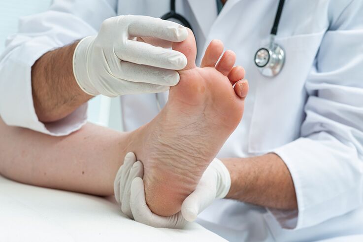 Le dermatologue examine les jambes du patient